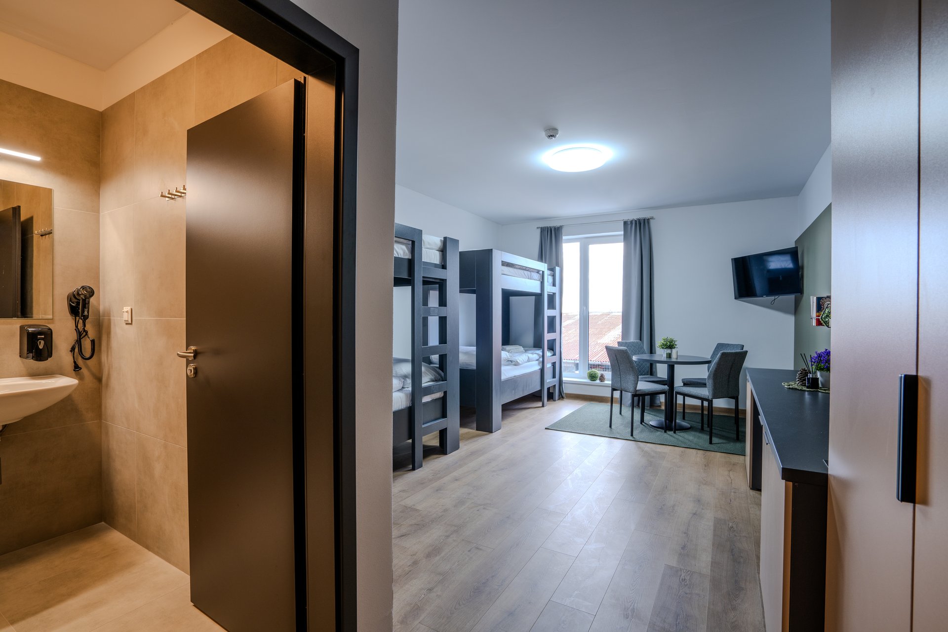 Quadruple room - stôl a TV